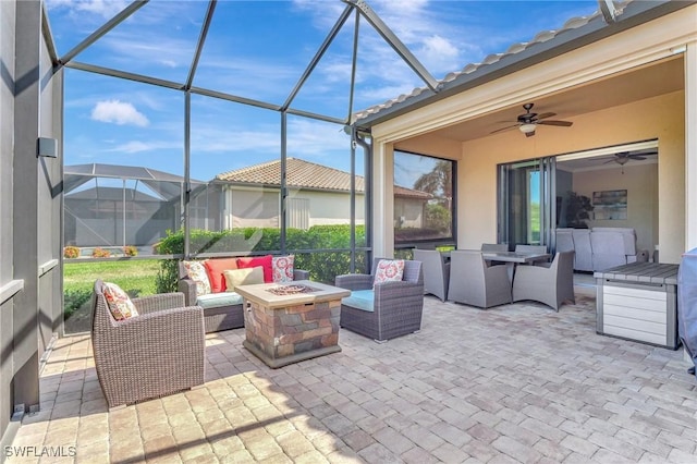 11716 Avingston Ter, Fort Myers, FL 33913 - view of patio / terrace with an outdoor living space with a fire pit, a lanai, and a ceiling fan