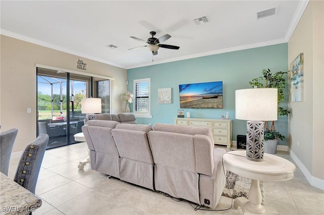 living area with visible vents, ornamental molding, light tile patterned floors, and a wealth of natural light