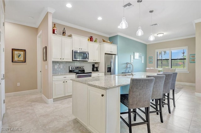 11716 Avingston Ter, Fort Myers, FL 33913 - kitchen featuring appliances with stainless steel finishes, a kitchen island with sink, a sink, a breakfast bar area, and tasteful backsplash