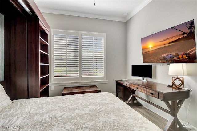 bedroom featuring crown molding and wood finished floors