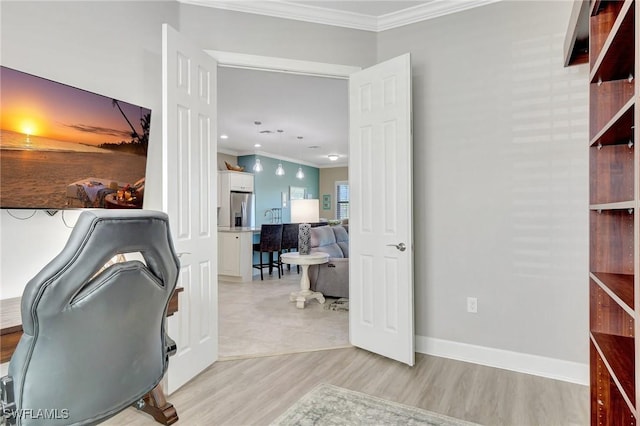 office with crown molding, baseboards, and light wood-style flooring