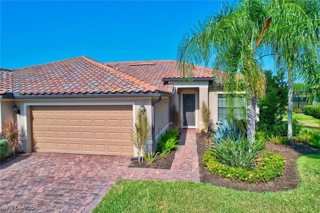 11716 Avingston Ter, Fort Myers, FL 33913 - mediterranean / spanish home with stucco siding, a garage, a tile roof, and decorative driveway