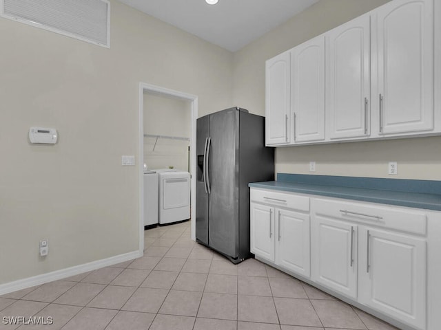 12156 Ledgewood Cir, Fort Myers, FL 33913 - kitchen featuring light tile patterned floors, washing machine and clothes dryer, stainless steel refrigerator with ice dispenser, white cabinetry, and visible vents