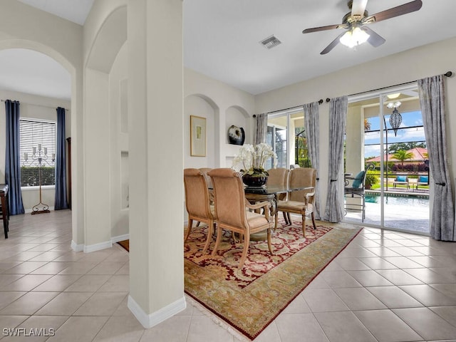 12156 Ledgewood Cir, Fort Myers, FL 33913 - dining room featuring baseboards, ceiling fan, visible vents, light tile patterned flooring, and arched walkways