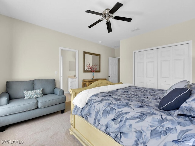 12156 Ledgewood Cir, Fort Myers, FL 33913 - bedroom featuring a closet, ensuite bath, visible vents, carpet floors, and a ceiling fan