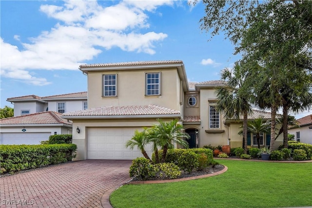 12156 Ledgewood Cir, Fort Myers, FL 33913 - mediterranean / spanish-style home featuring an attached garage, stucco siding, a tile roof, a front lawn, and decorative driveway