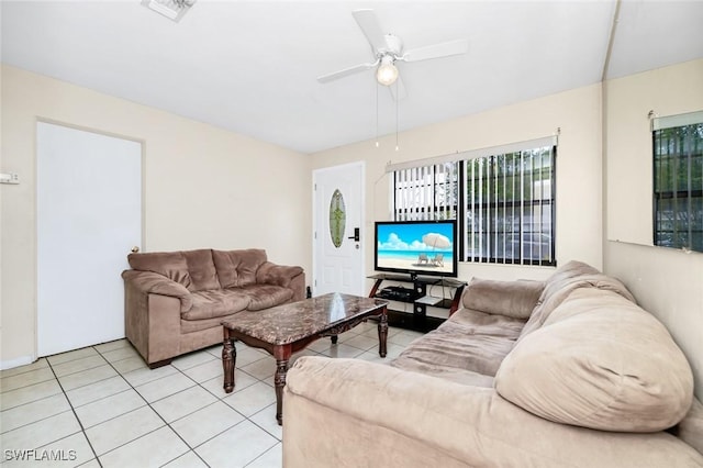 living area with light tile patterned flooring, ceiling fan, and visible vents
