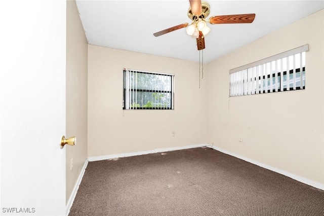 carpeted spare room with baseboards and ceiling fan