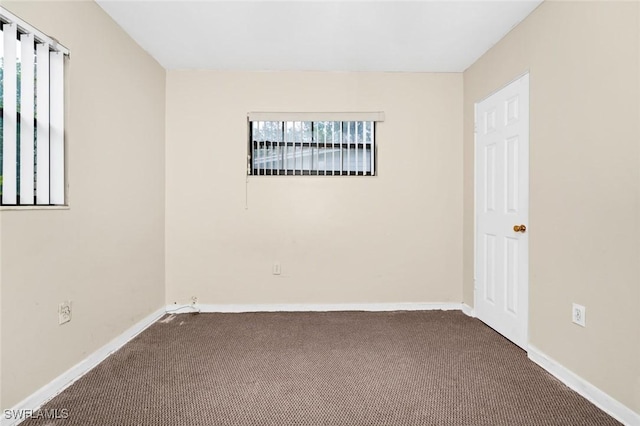 unfurnished room featuring baseboards and carpet