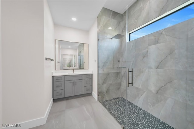 full bath with vanity, marble finish floor, baseboards, recessed lighting, and a marble finish shower