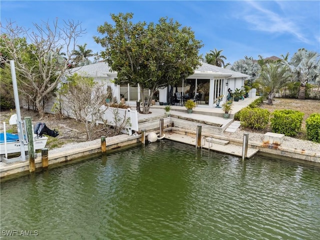 view of dock with a water view and a patio area