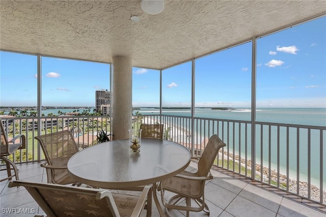 sunroom / solarium with a water view