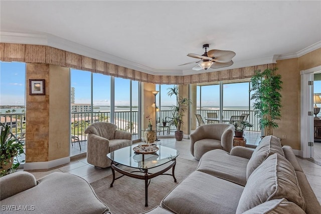 living room featuring plenty of natural light, a water view, and ceiling fan