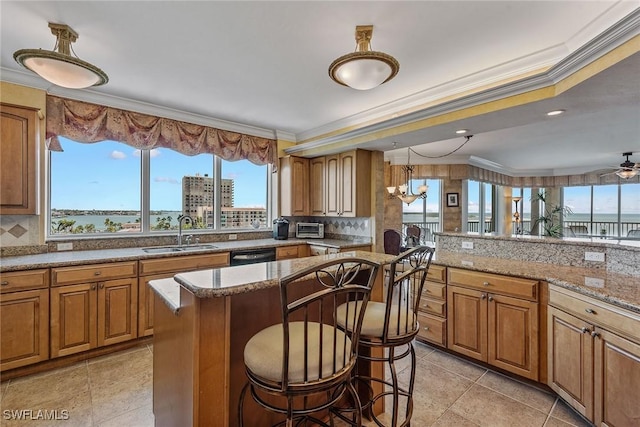 kitchen featuring crown molding, a sink, brown cabinetry, and tasteful backsplash