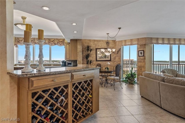 interior space featuring light tile patterned flooring, a notable chandelier, ornamental molding, recessed lighting, and pendant lighting