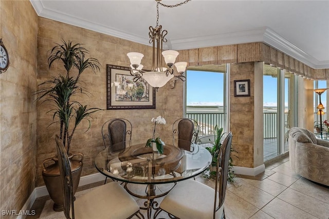 tiled dining area with baseboards, a chandelier, and ornamental molding