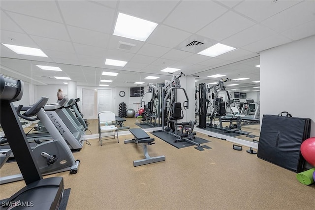 workout area featuring visible vents and a paneled ceiling