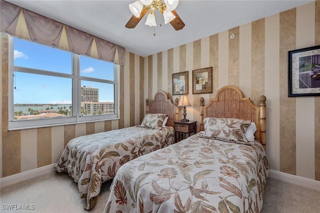 bedroom featuring baseboards, carpet flooring, ceiling fan, and wallpapered walls