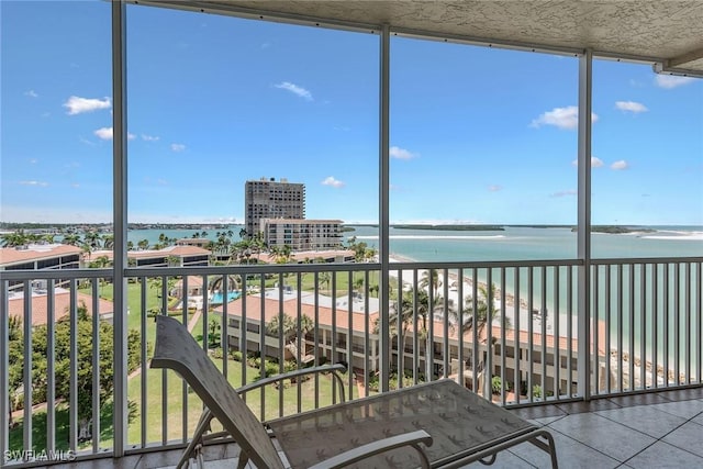 unfurnished sunroom with a water view