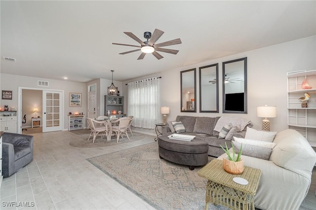 living area with a ceiling fan, visible vents, and recessed lighting