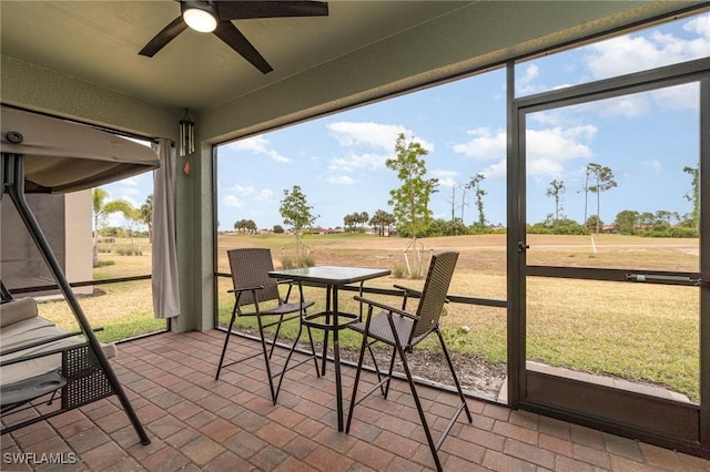 sunroom featuring a ceiling fan and a wealth of natural light