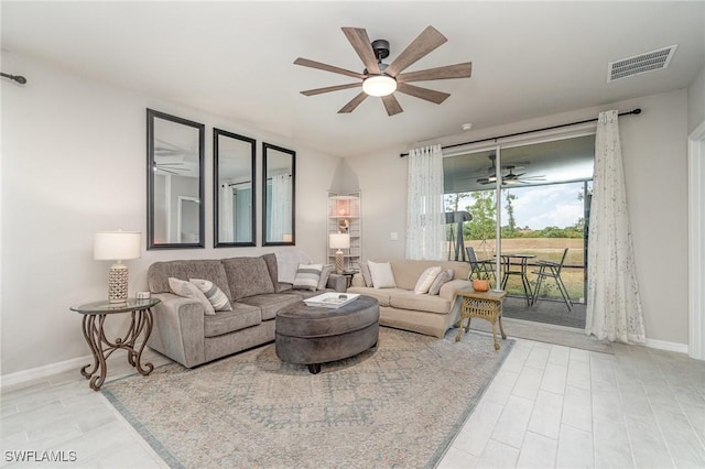 living area with ceiling fan, visible vents, and baseboards