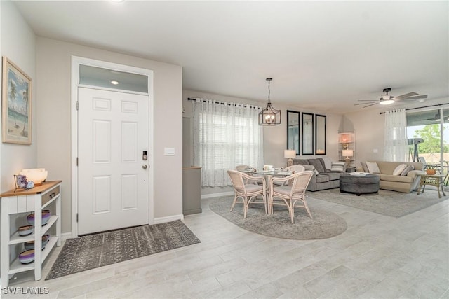 dining room with baseboards, light wood-style flooring, and ceiling fan