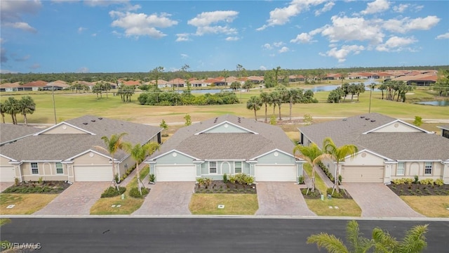 birds eye view of property with a water view and a residential view