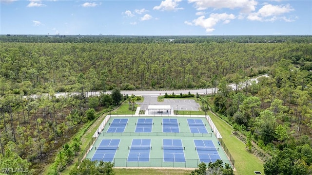 birds eye view of property featuring a view of trees