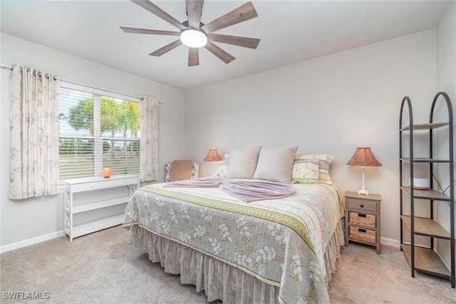 carpeted bedroom featuring baseboards and a ceiling fan