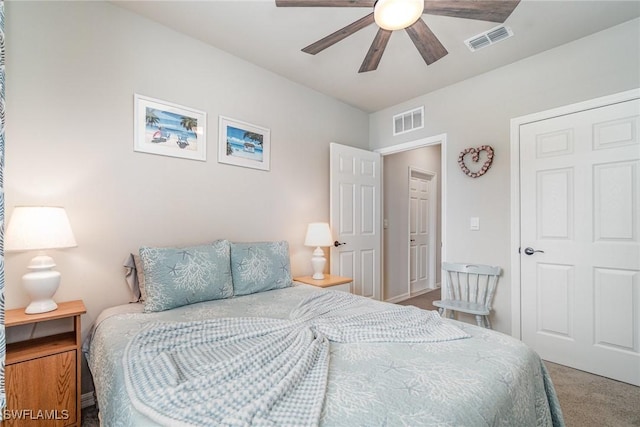 carpeted bedroom with visible vents and ceiling fan