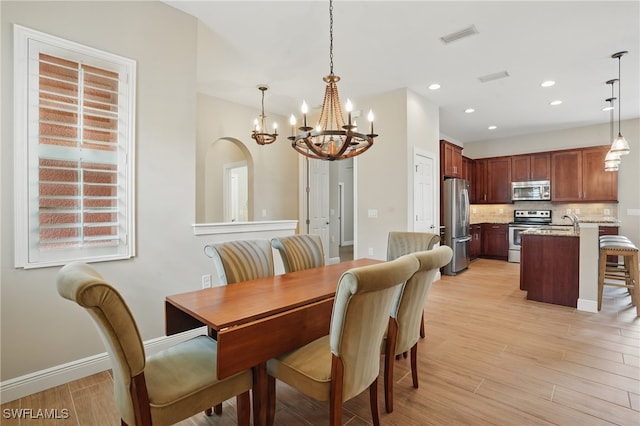 10419 Materita Dr, Fort Myers, FL 33913 - dining room with a chandelier, light wood finished floors, and recessed lighting