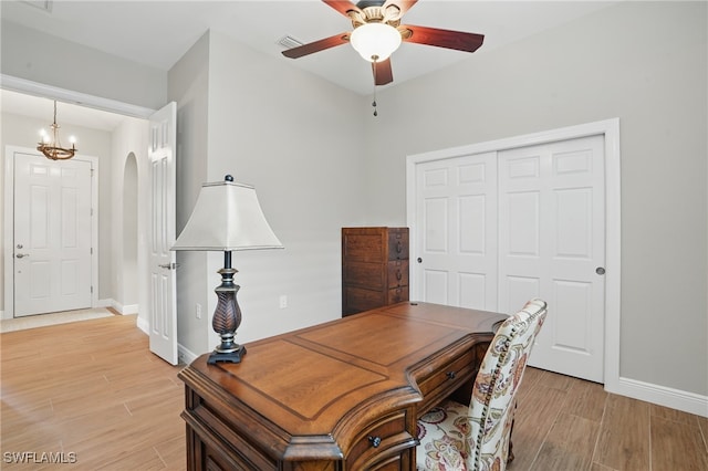 10419 Materita Dr, Fort Myers, FL 33913 - office with light wood-style flooring, ceiling fan, arched walkways, and a chandelier