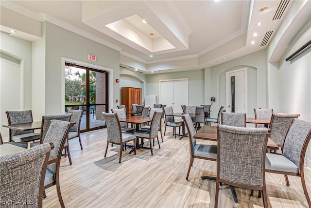10419 Materita Dr, Fort Myers, FL 33913 - dining space with arched walkways, recessed lighting, crown molding, a tray ceiling, and light wood-style flooring