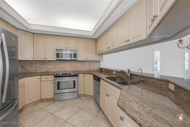 9380 Gulf Shore Dr Unit 101, Naples, FL 34108 - kitchen featuring appliances with stainless steel finishes, a sink, tasteful backsplash, stone counters, and light tile patterned flooring