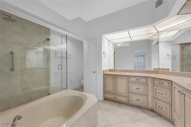 9380 Gulf Shore Dr Unit 101, Naples, FL 34108 - full bathroom featuring a stall shower, vanity, toilet, a garden tub, and tile patterned floors