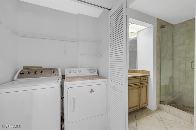 9380 Gulf Shore Dr Unit 101, Naples, FL 34108 - washroom featuring washer and dryer and light tile patterned floors