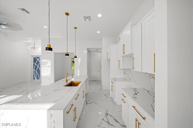 kitchen with visible vents, a sink, marble finish floor, and recessed lighting