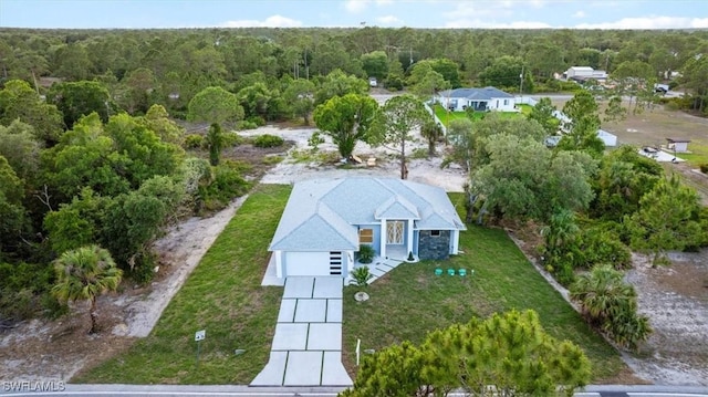 birds eye view of property with a view of trees