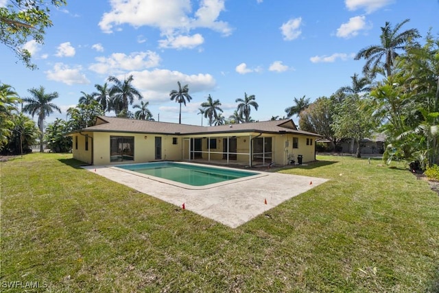 back of house with a lawn, a patio, a sunroom, and an outdoor pool