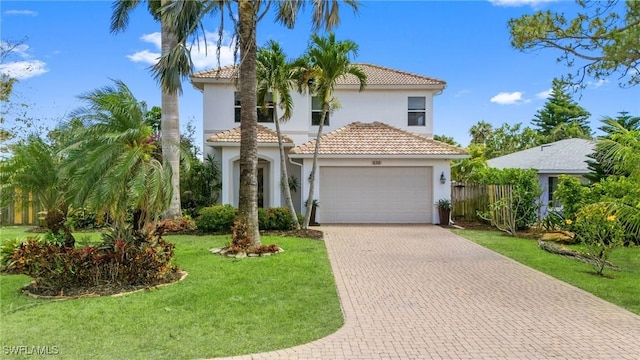 636 102nd Ave N, Naples, FL 34108 - mediterranean / spanish-style home with stucco siding, a tile roof, decorative driveway, and an attached garage
