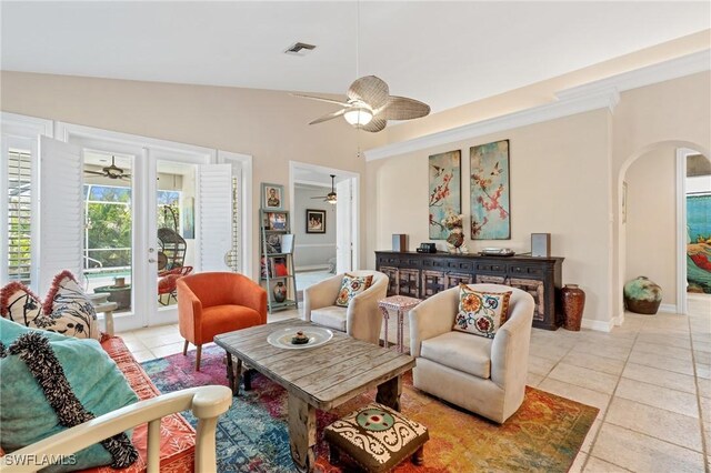 636 102nd Ave N, Naples, FL 34108 - living room with ceiling fan, arched walkways, light tile patterned floors, vaulted ceiling, and baseboards