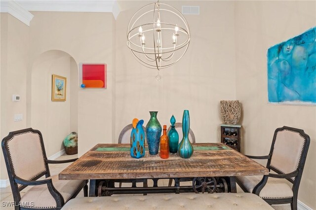 636 102nd Ave N, Naples, FL 34108 - dining area featuring baseboards, a chandelier, ornamental molding, and arched walkways