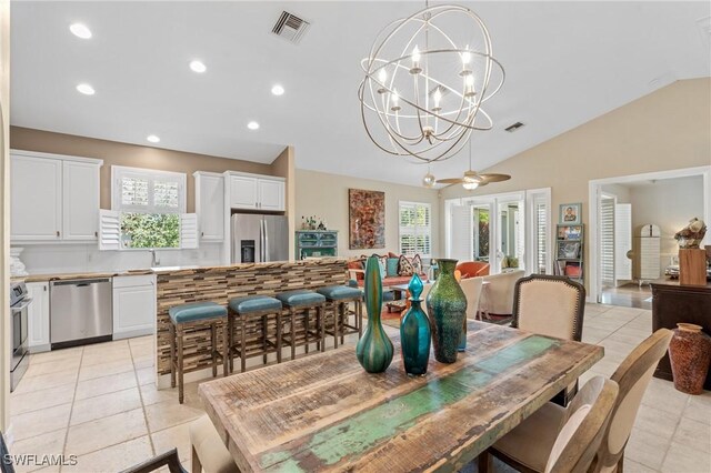 636 102nd Ave N, Naples, FL 34108 - dining room featuring vaulted ceiling, light tile patterned floors, recessed lighting, and a chandelier