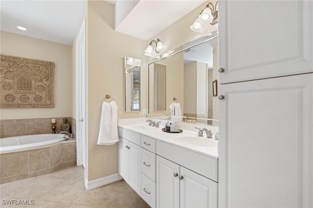 636 102nd Ave N, Naples, FL 34108 - full bathroom featuring tile patterned flooring, double vanity, a bath, and baseboards