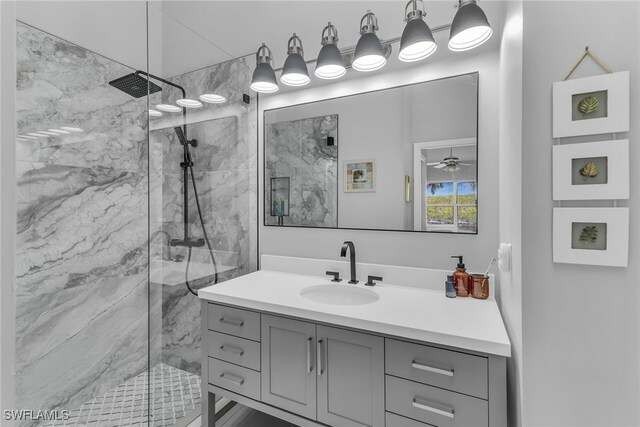 162 Newport Dr Unit 1208, Naples, FL 34114 - bathroom with vanity, a marble finish shower, and ceiling fan