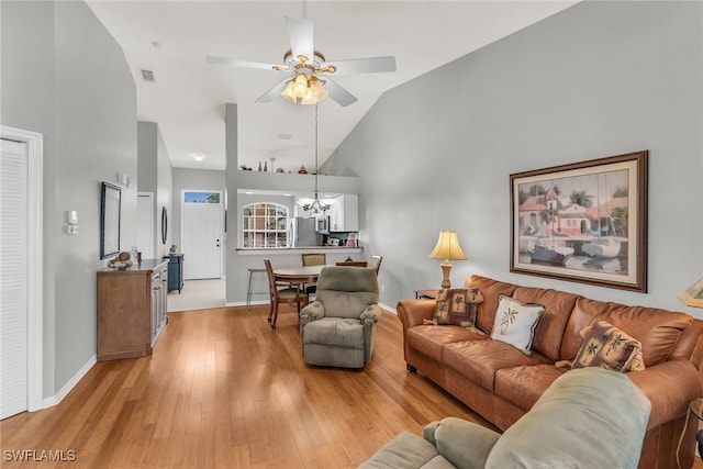 162 Newport Dr Unit 1208, Naples, FL 34114 - living area featuring high vaulted ceiling, baseboards, ceiling fan with notable chandelier, and light wood finished floors