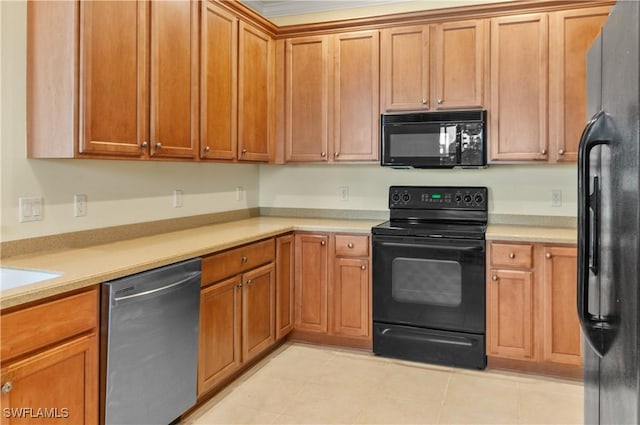 kitchen featuring light countertops, brown cabinets, light tile patterned floors, and black appliances