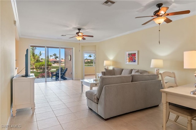 living area with plenty of natural light, ornamental molding, a ceiling fan, and visible vents