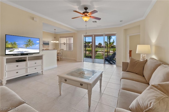 living room featuring ceiling fan with notable chandelier, baseboards, light tile patterned floors, visible vents, and ornamental molding